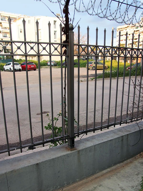 Heavy-duty metal railing on top of perimeter wall