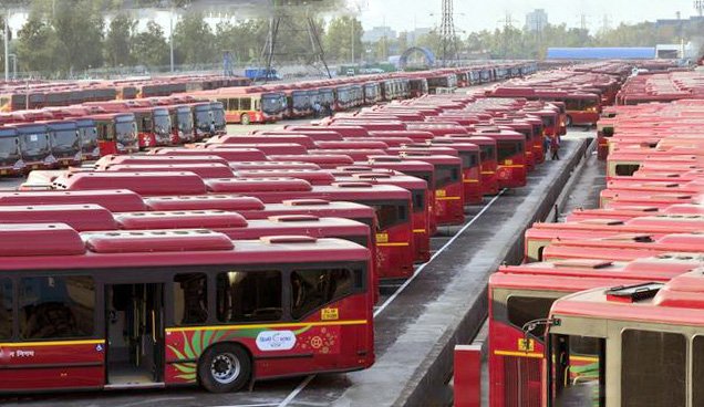 City buses parked in fenced depot
